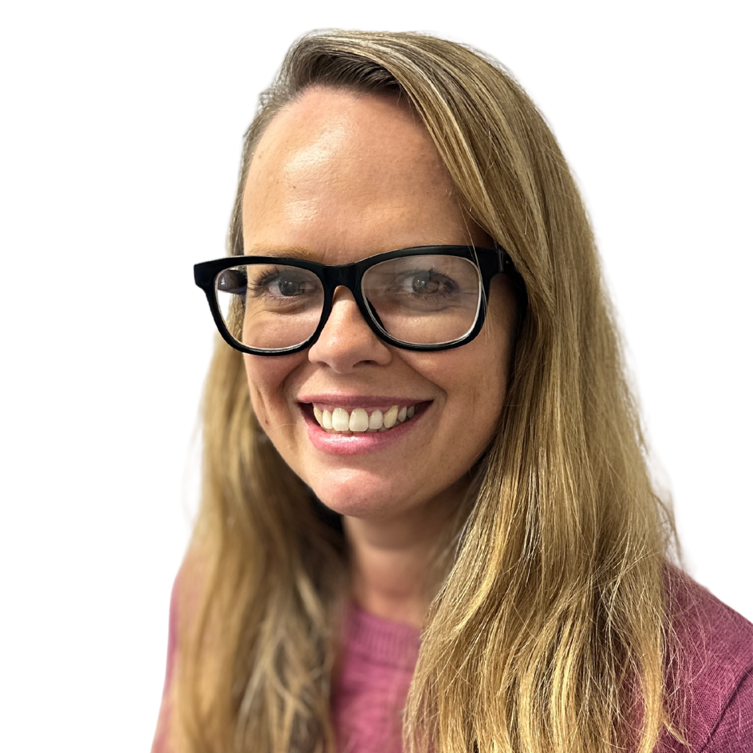 Smiling woman with long blond hair and black-framed glasses, wearing a pink sweater, looking toward the camera.